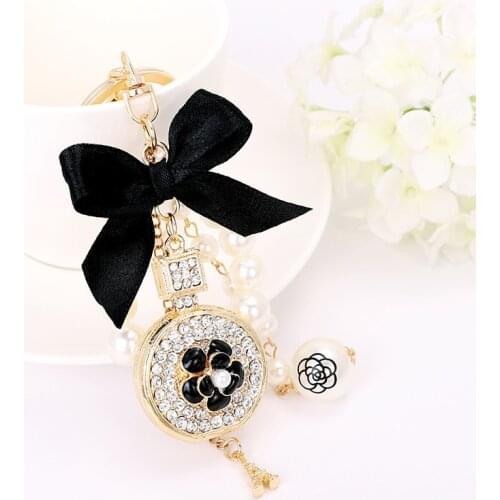 New creative handmade pendant perfume bottle butterfly knot shape alloy key ring pearl ornament