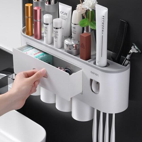 2021 New Magnetic adsorption inverted toothbrush holder with dual automatic toothpaste squeezer dispenser storage rack