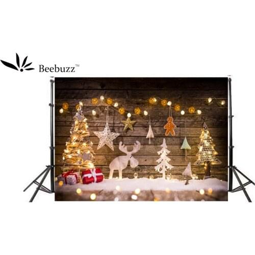 Beebuzz photo backdrop christmas tree gifts bells and stars decorate the background