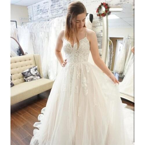 2020 New Beach Wedding Dresses Spaghetti Strap Backless Appliques Wedding Gowns Custom Made A-Line Bridal Dresses Sweep Train