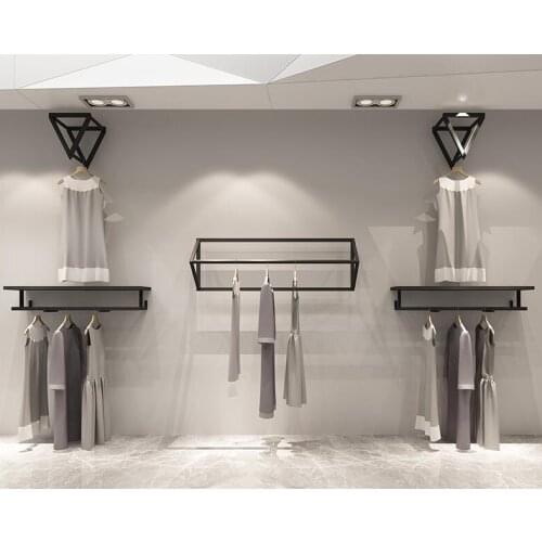 Clothing store display rack wall. Simple wall hanging womens shop hangers. Shelves. Childrens clothes shelves..057
