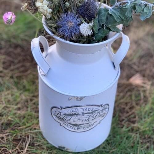 Handcrafted white farmhouse iron milk can flower display