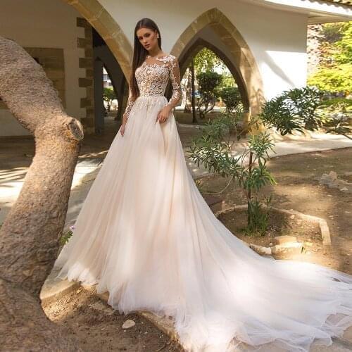 Gorgeous Long Sleeve Wedding Dresses 2021 A-Line Sheer O-Neck Lace Appliques Sweep Train Ivory Bridal Gown Button Back Tulle