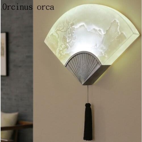 The new Chinese style relief fan wall lamp dining room balcony bedroom bedside lamp China wind resin creative wall lamp