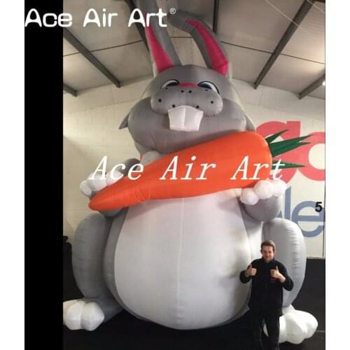 Giant 20ft Easter inflatable sitting bunny rabbit holding a carrot for advertising