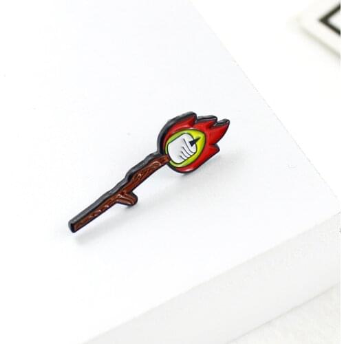 The match is braving the red flame. There is a candle in the middle of the burning brooch that represents the fire of life