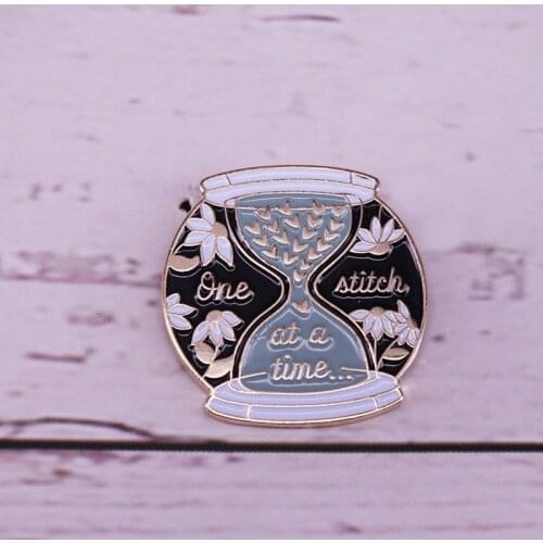 One stitch at a time enamel pin hourglass badge