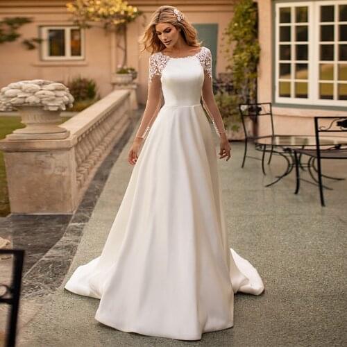 2021 Modest Satin Scoop neckline A Line Wedding Dresses With Pockets Lace Appliques Long Sleeves Buttons Back Bridal Gowns