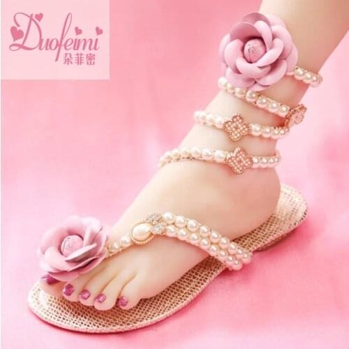 Original sexy snake-shaped tangled strappy womens shoes small fragrant camellia pearl flat bottom fashion Roman womens sandals