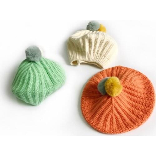 New spring and autumn fashion childrens beret two-color fur ball baby cute solid color knitted hat Cute warm hat for children