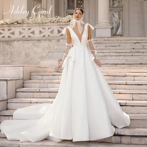 Ashley Carol A-Line Wedding Dress 2021 Charming Beaded Deep V-Neckline Satin Bride Flower Sleeveless Bow Princess Bridal Gowns