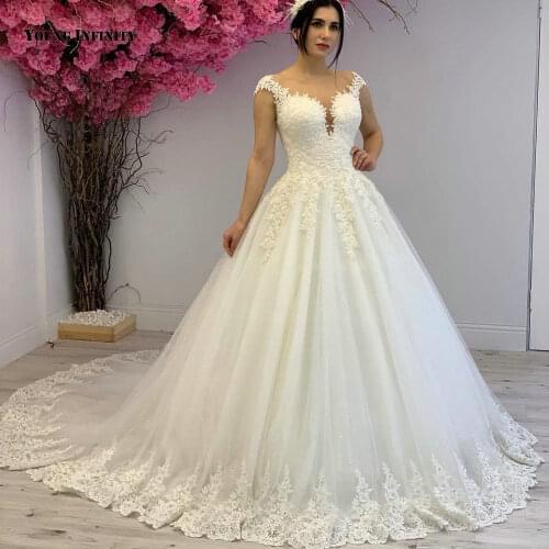 Lovely Ball Gown Wedding Dresses 2021 Sleeveless Bridal Gown Illusion Back Scoop Chapel Train Beading White Plus Size Bride