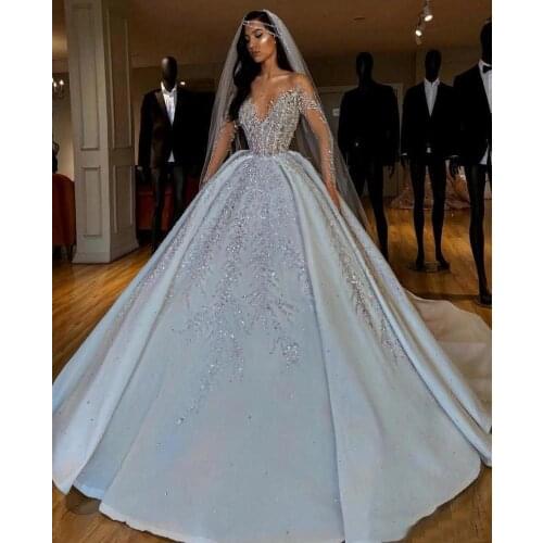 Luxurious Arabic Crystals Sequins Wedding Dresses Ball Gown 2021 Sheer Long Sleeves Bling Sparkly Dubai Garden Bridal Gowns