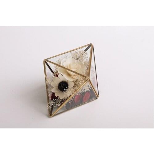 New home or shop decoration, glass vase with golden metal frame with flower inside, fashion design