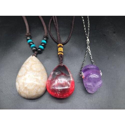 Hand-carved skull with natural quartz crystals. Coral jade. Red crystal pendant. Chakras