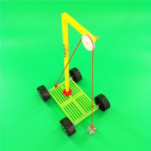Boy and girl gravity trolley DIY small making small invention science physics experiment hand-made puzzle assembling toy