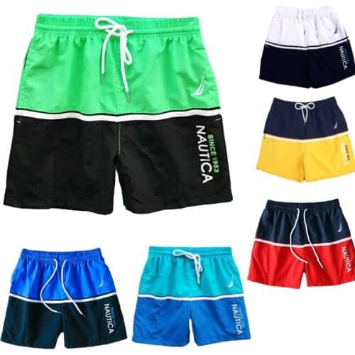 Shorts mens color matching fashion trend casual three-point sports pants home outdoor elastic beach pants spring and summer