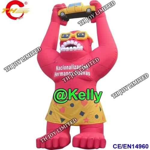 Free door shipping giant inflatable gorilla wearing skirt holding a car model, outdoor advertising inflatable monkey model