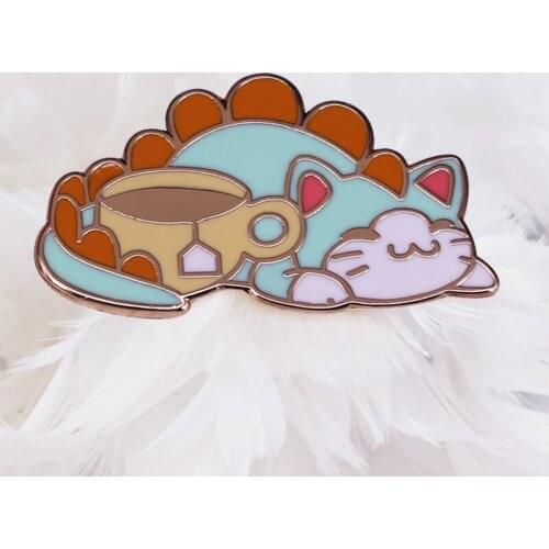 Do you love tea more than T-Rex? This unique hard enamel pin will show off your dedication to a good Cup of Tea on any bag acce