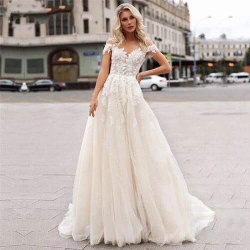Sheer Neckline Wedding Dresses 2021 A-Line Short Sleeve Lace Appliques Sweep Train Illusion Tulle Bridal Gown Pearls Button Back