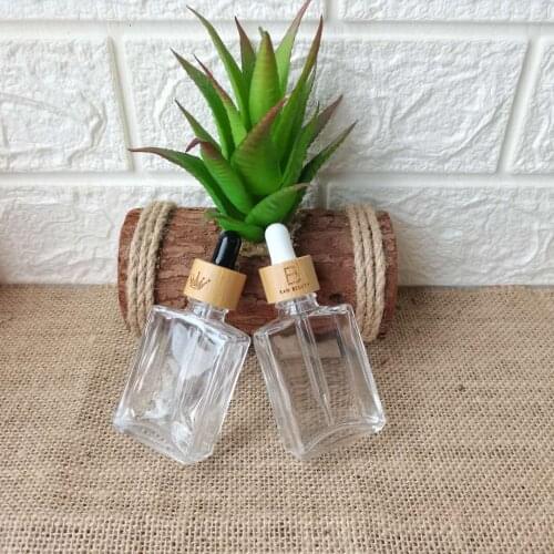 105pcs 50g 72pcs 100g frosted clear glass jars with bamboo cap with engraving logo for face cream