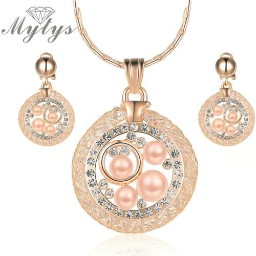 Mytys New Design Circle Pendant Necklace and Earring Sets Crystal Mesh Net Pearl Heart Jewelry Sets for Women CN285