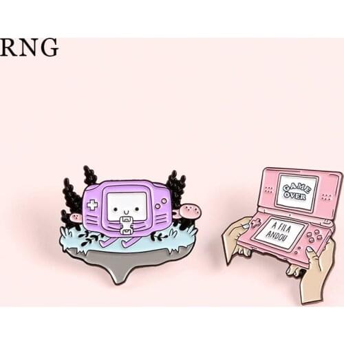 RNG pink and purple smiley face tree game machineBroochessitting on the mountain game over display hands holding the metal pins