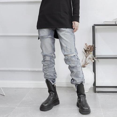 Yamamoto style dark big womens light color jeans with zipper at the bottom and holes in the pants