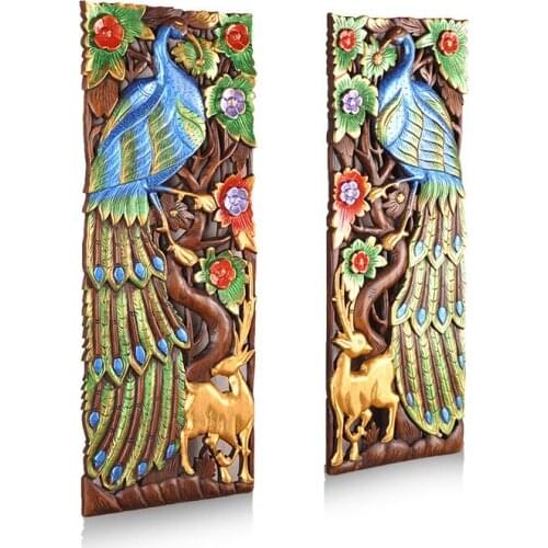 Hand carved peacock in Thai wood panel decoration background wall decoration in Southeast Asia