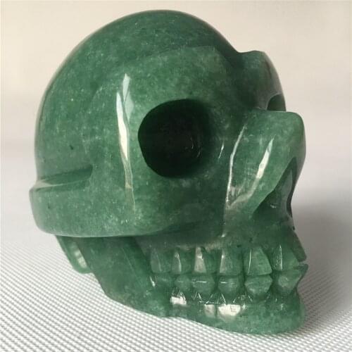 Natural quartz crystal skull for sale Stones home decorative Halloween Wrapped in tourmaline and mica