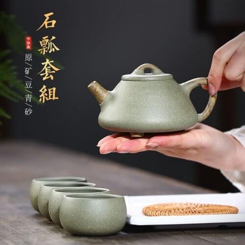 Twisted clay and stone ladle pot, one pot with green pea and stone ladle pot, one pot with Kung Fu teapot and tea set