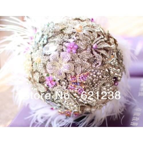 Holding flowers lilac feathers, ostrich feather & brooch bouquet ideas, wedding jewelry of choice for holding flowers
