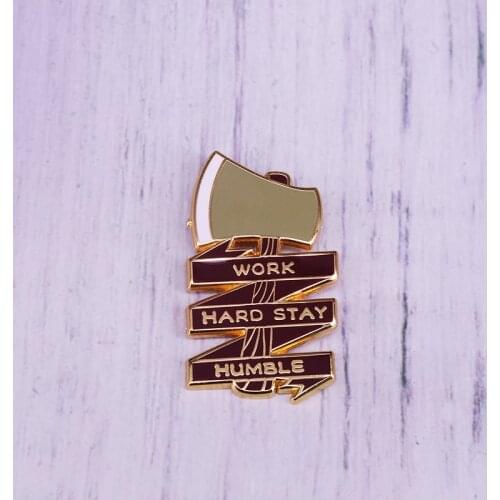 Keep your mantra on your person with this lumberjack-inspired axe brooch pin Work Hard Stay Humble enamel Pin