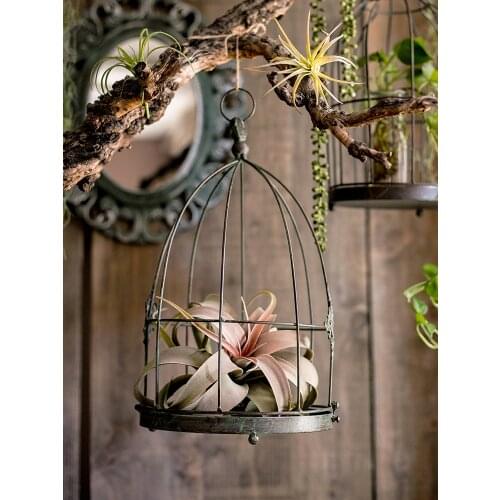 Using vintage rustic metal bird cage for decor