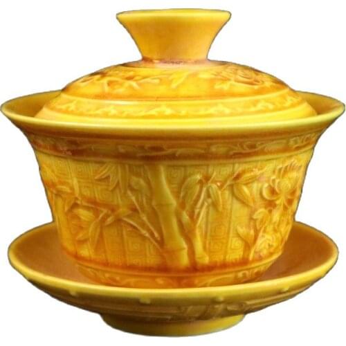 A yellow relief teacup painted with a pattern of plum orchid bamboo and chrysanthemum on Chinese porcelain