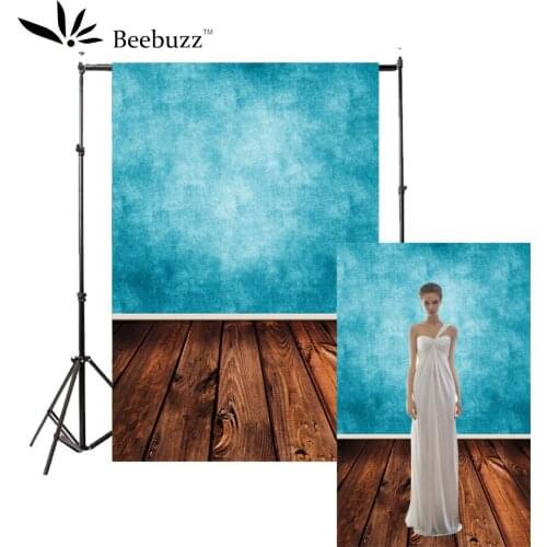 Sky blue gradient light wall and dark brown wooden floor background Photography studio photophone model Portrait photo