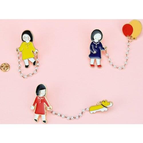 Cute little girl walking the dog, putting a balloon pin badge, a brooch decorated on the collar, a gift for the child