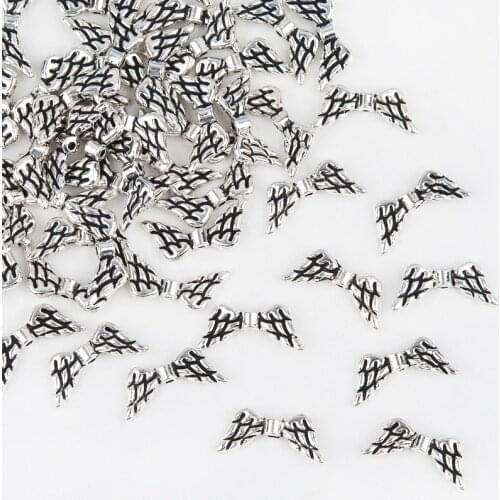 DoreenBeads Zinc metal alloy Spacer Beads Wing silver color Pattern color About 20mmx9mm,Hole:Approx 1.2mm,10 PCs