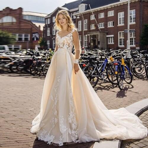 Tempting Champagne Mermaid Wedding Dresses with Detachable Skirt Ivory Lace Appliques Sheer Scoop Tulle Long Sleeves Bridal Gown