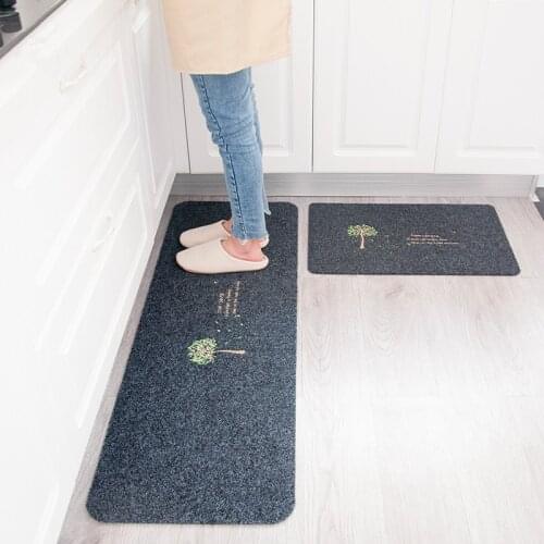The kitchen floor is made up of a long strip of oil - proof foot mat bathroom door mat
