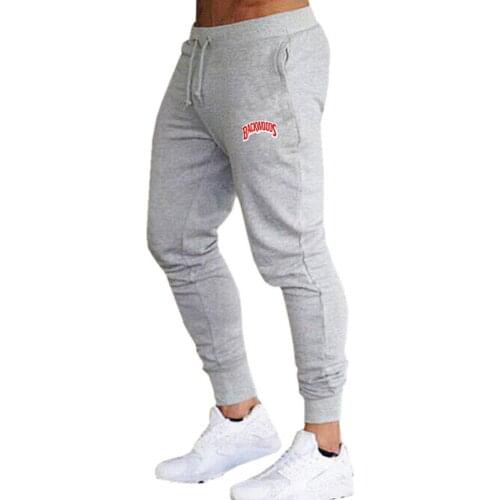 Sell the hot solid casual mens sports casual fitness suit solid male fitness cotton tight jogging casual trousers
