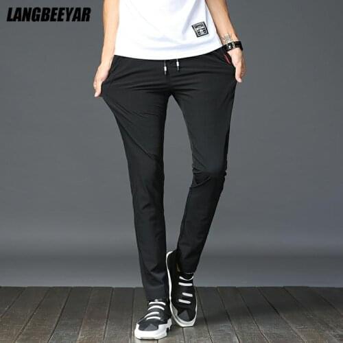 Top Quality New Brand Casual Fashion Compression Quick Dry Long Pants Men Slim Fit Elastic Strappy Trousers Mens Clothing