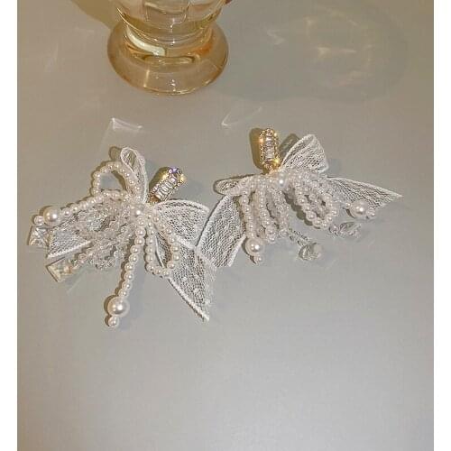 Minar Hyperbole White Colour Lace Faux Pearl Cross Knotted Pendant Earrings for Women Ladies Shiny CZ Stone Geometric Earrings