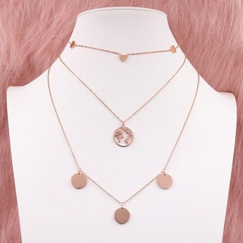 Mavis Hare Multilayer necklace wearing the Multi Heart Choker Necklace Multi Coin Necklace combined with the World Necklace