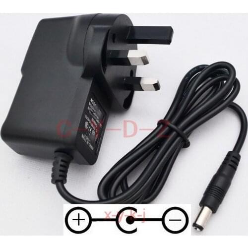 1PCS High quality AC/DC 9V 1A UK Switching Power Supply For guitar foot pedal Effect adapter Reverse Polarity Negative Inside