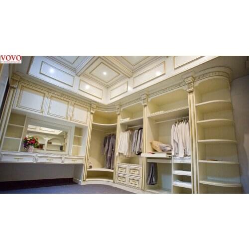 White walk in wardrobe with gold painted Roman column