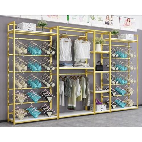 Underwear store display stand against the wall bra is hanging on the floor clothing underpants display shelf gold