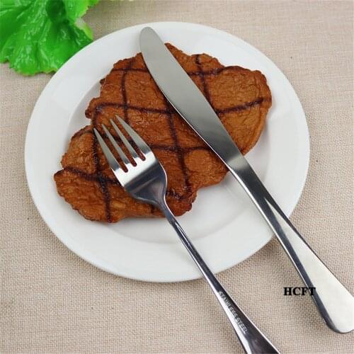 Fake beefsteak burgers shrimp crab corn french fries abalone sausage broccoli onion tomato slices mushroom beef steak props