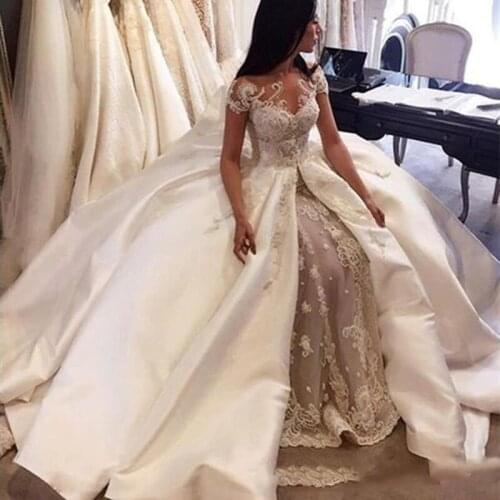 Luxury Ball Gown Wedding Dresses 2020 Saudi Arabia Cap Sleeve Lace Applique Satin Overskirt Bridal Gowns Custom Made Dubai Weddi