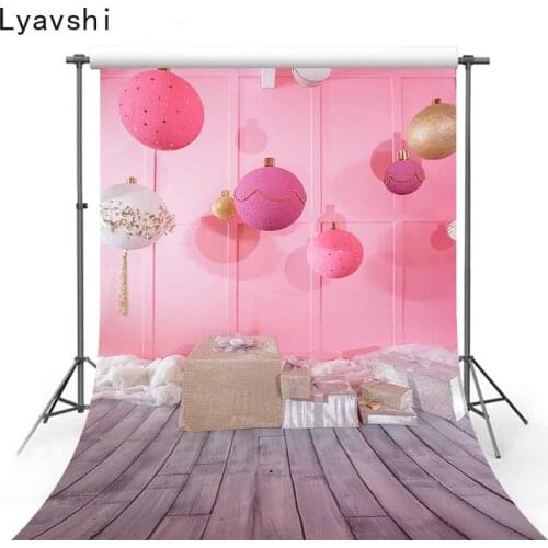 Lyavshi in the childrens room pink children birthday party on the background of the large Christmas ball photography background